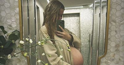 Pregnant Stacey Solomon poses in just a robe as she shows off her baby bump