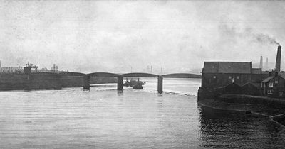 The industrial River Tyne and a now-defunct railway bridge 95 years ago