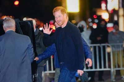 Harry waves to fans as he arrives at Stephen Colbert’s The Late Show with armed security