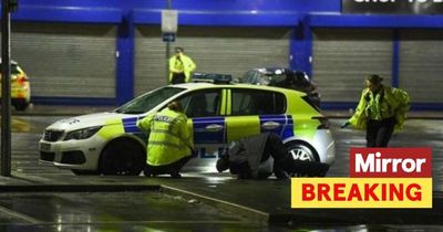 Man stabbed 'for his shopping' in Aldi car park with police manhunt underway