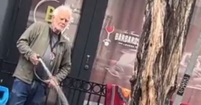 'Evil' man filmed casually blasting homeless woman with HOSE - and he has no regrets