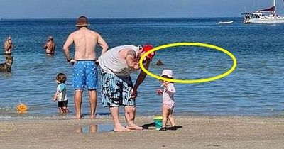 Family beach photo with scary detail in background sparks fiery online debate