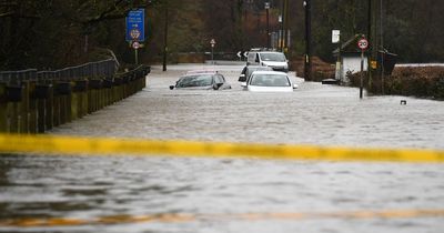 Cars abandoned and submerged as village road turns into river