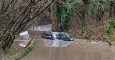 Fire service's warning after rescuing driver from flooded car submerged in water