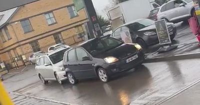 Road rage row as driver rams into the back of rival car at petrol station and hurls drink