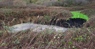 'Gigantic' sinkhole appears on popular walkway near road