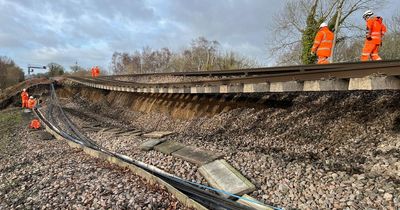 Heavy rain sees landslip hit train line leaving track hanging in mid air and rail chaos