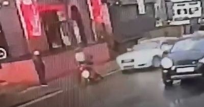 Shocking moment Audi driver mows down motorcyclist in busy street sparking police hunt