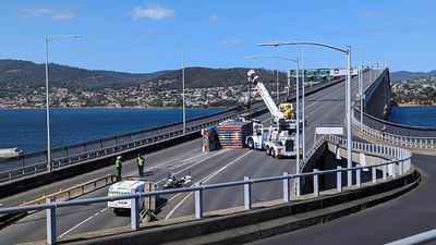 Truck driver rescued after bridge rollover leads to major traffic delays