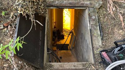 Camouflaged drug bunker found during police raid in Adelaide's south, two men arrested