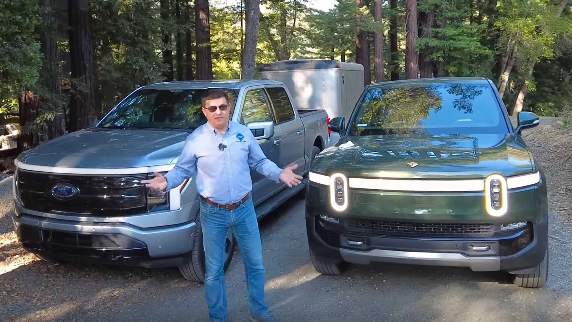 Rivian R1T towing a heavy trailer on a rural road