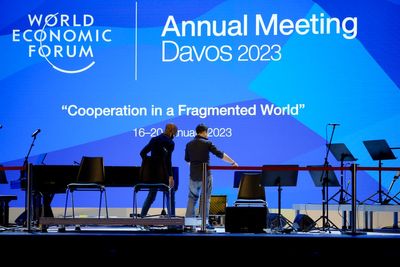 As elites arrive in Davos, conspiracy theories thrive online