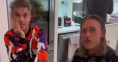 Take That fans have 'year made' as almost unrecognisable Robbie Williams and Mark Owen seen together - in high chairs