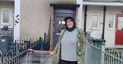 Woman collects abandoned shopping trolleys in front garden