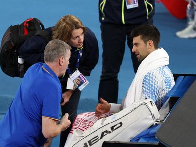 Djokovic taking hamstring injury ‘day to day’ as he progresses in Melbourne