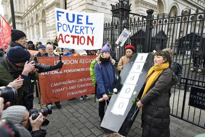 Protesters against cold-related deaths carry coffin to Downing Street