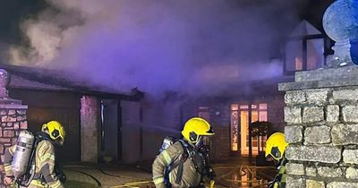 House engulfed in flames as fire breaks out in log store in middle of night