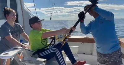 Boy, 12, catches 11ft great white SHARK on family trip as mum holds on for dear life