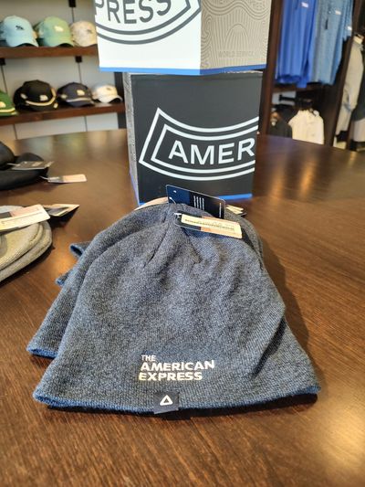 Knit hats? Long sleeves? Chilly weather has made these items popular at the American Express merchandise tent