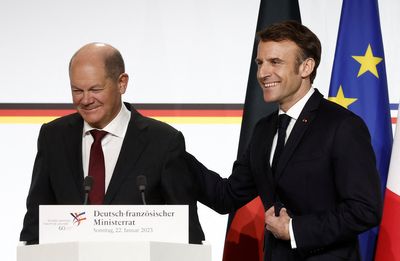 French and German leaders gloss over divisions at summit