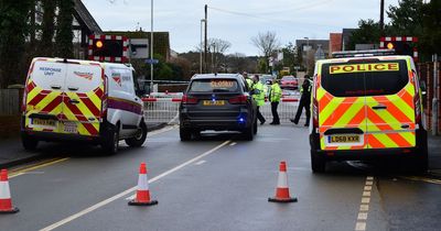 Road closed and 'heavy traffic' after bus crashes into level crossing