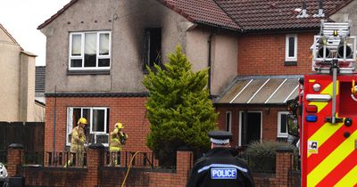 Couple pulled from burning house as window blown out