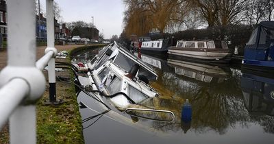Boat filled with old cans of Carling sinks in the Bridgewater Canal