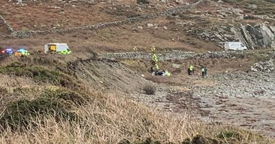 Car flips onto roof after plunging down embankment on Scots road as air ambulance called