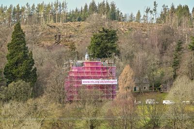 Castle swathed in seven-storeys of pink mesh for conservation work