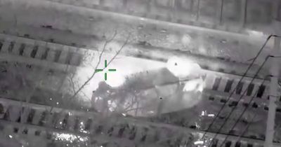 Suspect dragged from stolen police car seconds before it's hit by train