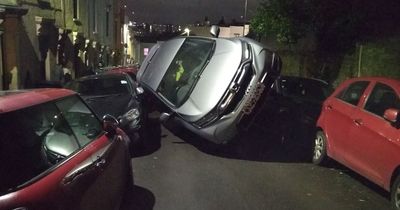 Car flips over and crashes into parked vehicles in quiet Bedminster street