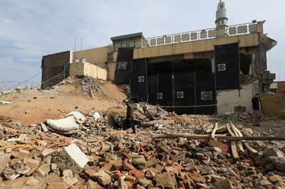 Pakistan says mosque bomber wore police uniform, breached security on motorbike