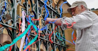 Abuse survivors tie ribbons to St Mary's where Cardinal George Pell lies in state