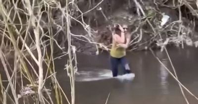 Incredible moment woman wades through river to save her missing dog after terrifying call