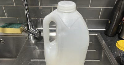 Why are coloured lids on milk bottles are being replaced with clear caps?