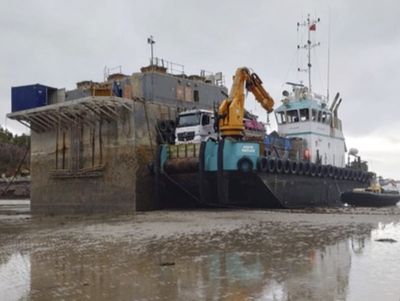 ‘Toxic’ barge that sank more than a year ago is still beached in a scenic bay