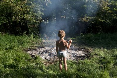 A boy stares into the remains of a fire during lockdown – Léonie Hampton’s best photograph