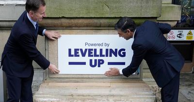 Rishi Sunak slammed for 'fly posting' as he leaves levelling up poster on old building