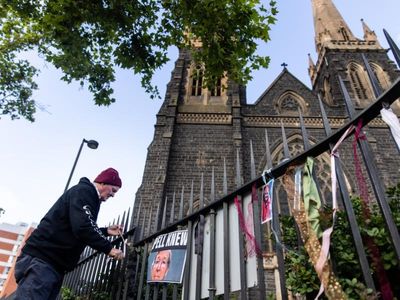 Protesters tie ribbons outside Melbourne mass for Pell