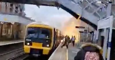 Train bursts into flames forcing passengers to run for their lives as smoke fills sky