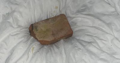 Mum's terror as brick smashes through window, narrowly missing her newborn baby