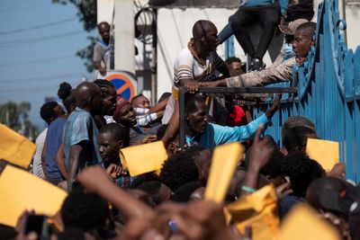 Haitians seen crushing into migration centers seeking passports to U.S