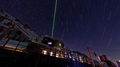 From a snowy alpine lair, lasers pierce the night