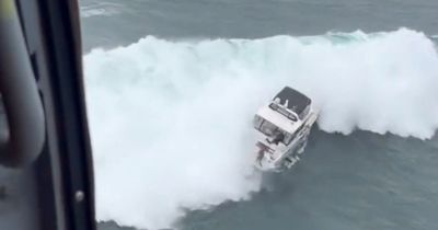 Watch rookie coast guard swimmer rescue sailor as massive wave crushes his yacht