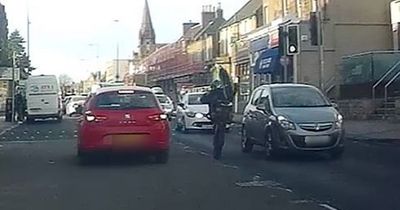 Heartstopping moment idiot biker 'pulls wheelie' in heavy traffic on Scots road