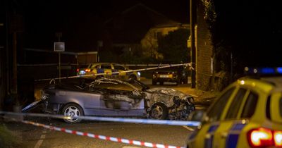 Car hits three people before crashing into wall and bursting into flames