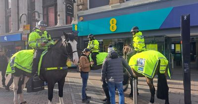 Large crowd brand Leeds mounted police a 'joke' after surrounding man on bench