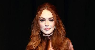 Lindsay Lohan glows in ultra rare public appearance with family at Fashion Week