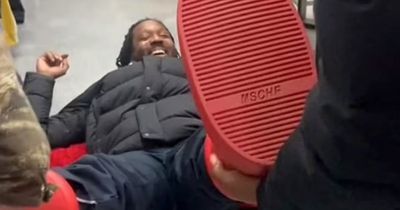 Panicked man desperately tries to remove $350 red shoes after they get stuck