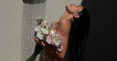 Kylie Jenner poses totally nude in the shower covering modesty with some flowers